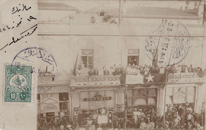 A photocard from the summer of 1908, possibly showing celebrations in the city of Salonica in support for the Young Turk Revolution that happened just a month before, with the discontent and rebellion starting within the locally based 3rd Army Corps in the Ottoman sancak of Macedonia, of which Salonica was the capital.