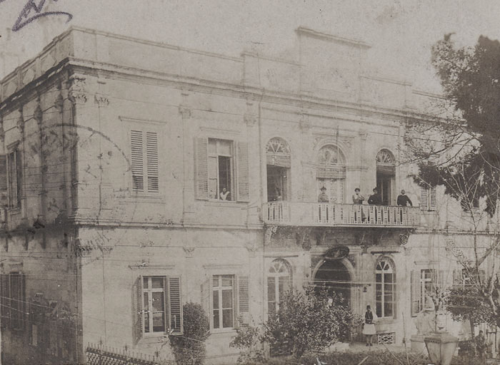 A photocard from the the early 20th century with what looks like the house of a prominent Turkish official, complete with the seal of the Sultan above the front door.